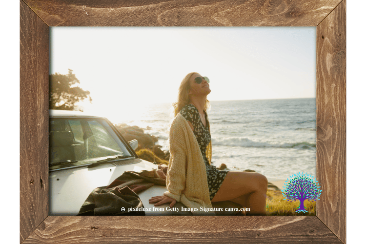 Woman sitting on her white car in the sun, smiling near the beach side