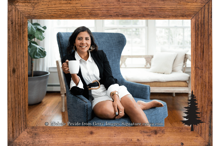 Woman sitting in a blue chair smiling with a cup of tea, appearing to feel confident.