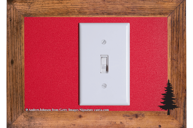 White plated light switch with red wall as background.