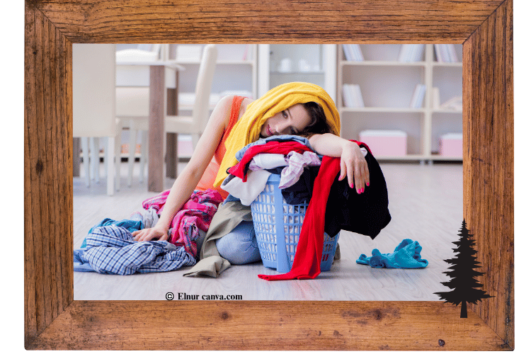 Woman slumped over laundry basket appearing to be tired and stressed.