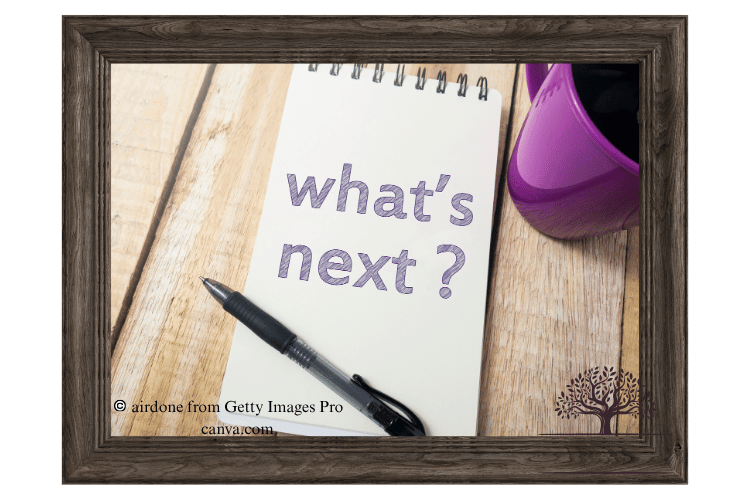 Small memo notepad sitting on desk with the words "what's next?"